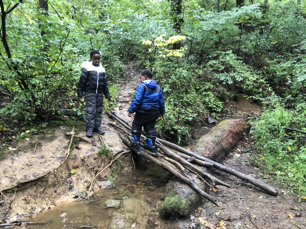 2 kids built a bridge at stream